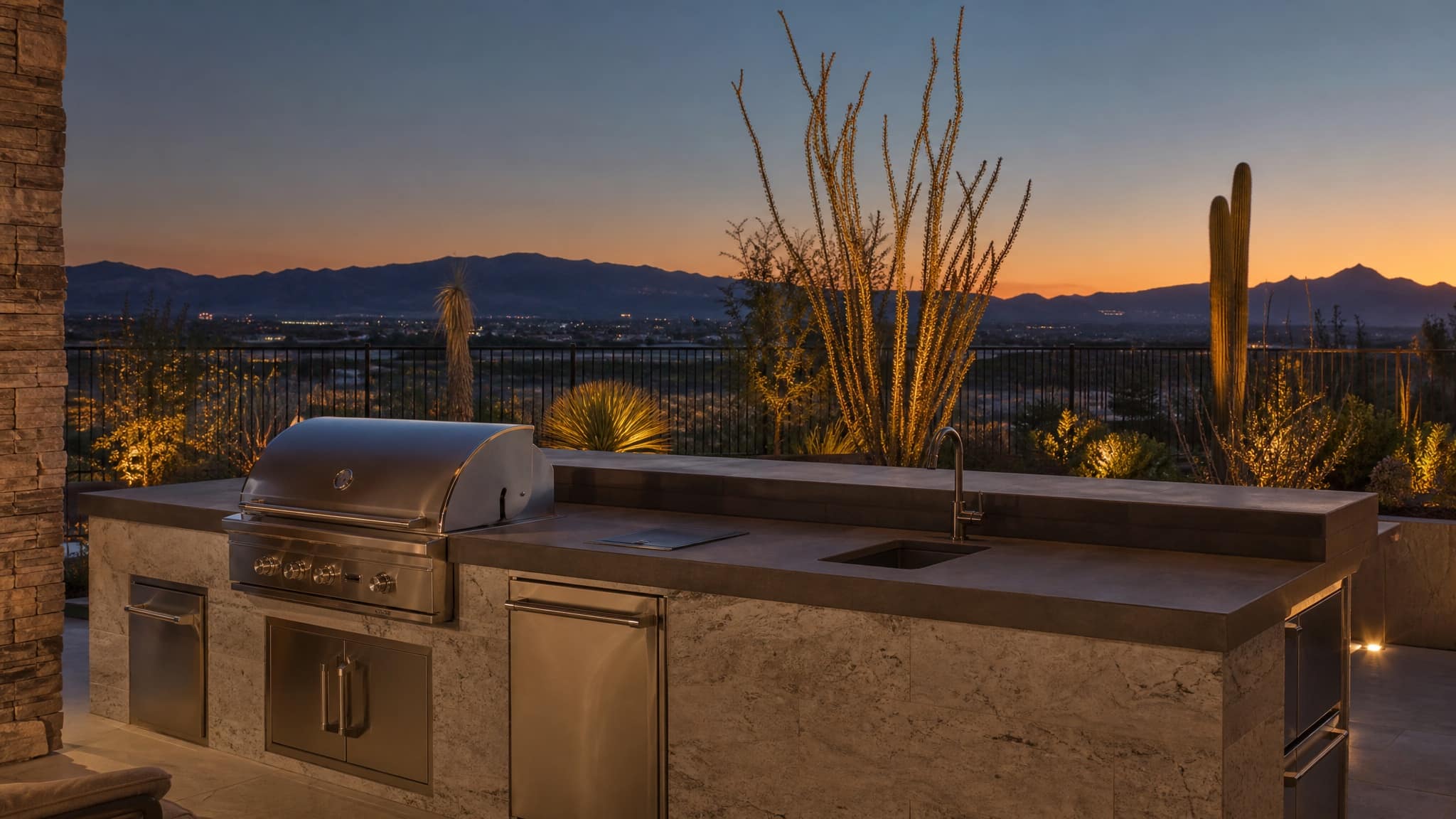 Outdoor kitchen with stone countertops at dusk